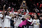 South Carolina's players and coach celebrate after the college basketball championship game against Iowa in the women's NCAA Tournament on Sunday. South Carolina won 87-75.