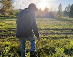 Álvaro Aguilar walks across his two-acre farm in rural Washington County on April 18, 2025. Aguilar took the Adelante Mujeres agriculture course in 2018 and now runs Real Tex Mex with his wife.