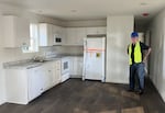 HOPE Board President Terry McDonald inside of the nonprofit's first new mobile housing unit, which is being sent to Southern Oregon. The single-wide model has a floorplan of 728 square feet.