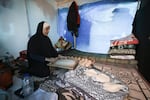 A displaced Palestinian woman prepares bread inside a tent at a makeshift camp in Rafah near the Gaza-Egypt border earlier this month.