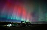 An aurora borealis makes an appearance over pumpjacks as they draw out oil and gas from well heads near Cremona, Alberta, Canada, on Oct. 10.