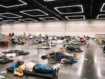 People rested at the Oregon Convention Center cooling station in Portland, Oregon during a record-breaking heat wave in 2021. FEMA has never responded to an extreme heat emergency, but some hope that will change. (Photo by Kathryn Elsesser / AFP via Getty Images) 