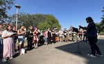 SOU graduate student Martin Bichinsky directs a choir of protestors on May 8, 2026.