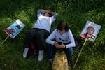 People rest during a break outside of Kibbutz Alumim, Israel, which was attacked on Oct. 7, as families of the hostages held in Gaza and supporters march from southern Israel to Jerusalem on Feb. 28.