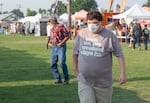 A fairgoer wears an N95 mask while attending the Crook County Fair in Prineville, Ore., on Aug. 5, 2026.