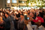 People hold candles during a candlelight vigil and prayer event for Kirk on Wednesday in Seattle, Washington.