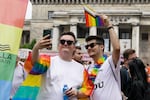 People take a selfie with rainbow Pride flags before the start of the Equality Parade in Warsaw, Poland, in June 2023. The Equality Parade was celebrated under the slogan "We predict equality and beauty!"