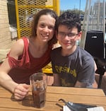 Robin Marie and her 13-year-old son Brennan pose for a photo earlier this spring at a restaurant in Texas. Marie was visiting her son who's living and attending school at an out-of-state residential treatment facility paid for by his local school district and the state. 