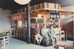 Restaurateur Michael Vidor, left, and Bob Shimabukuro, right, sit near the rustic decor inside the Tanuki restaurant they co-owned in Southeast Portland.