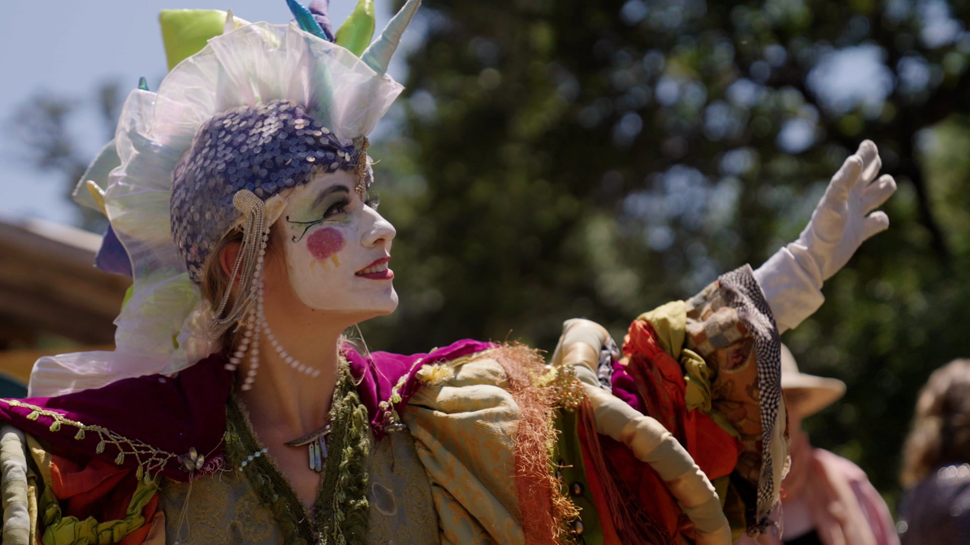 Maddy McKee of Calliope Circus greets visitors as they enter the Oregon Country Fair on July 13, 2024.