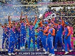 India's players celebrate with the winners' trophy after winning against South Africa in the ICC Men's T20 World Cup final cricket match at Kensington Oval in Bridgetown, Barbados, on Saturday.