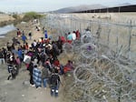 Hundreds of migrants set up camp on the Rio Grande, waiting for Texas National Guard agents to let them enter the border wall in Ciudad Juarez, Mexico on March 20, 2024. In the improvised camp there are infants and women, who sleep a few meters from gate 36 with the hope of being able to pass the knife fence.