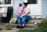 Lewis hugs her daughter, Gianna, outside their home in Indianapolis.