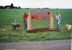  Harlan and Beverly Flint help to install sign at Mid Valley Farm in 1983.