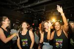 Lindsey Falasca (left) dances with her friends in matching shirts as they celebrate her 40th birthday. Their shirts read "Lettuce turnip the beet."