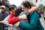 Melissa Valenzuela embraces Mika Davies and Jan Klepinger after finishing the Portland half marathon on October 6, 2019.
