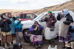 Tatum Ganuelas, Jill-Marie Gavin, Lisa Faye McIntosh-Gavin, Shawna Gavin, Jolie Wendt, and LeAnn Alexander, from left to right, finish their picnic lunch with a drink of water, or cuus. They started off the meal with a taste of the tribes’ traditional First Foods: salmon, meat, roots, chokecherry, and huckleberries. The meal began and ended with water in acknowledgement of the vital role it plays for all living things on earth.