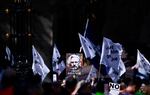 Supporters of WikiLeaks founder Julian Assange, fly a banner featuring an image of Assange, as they protest in support of him, outside The Royal Courts of Justice, Britain's High Court, in central London on Monday.