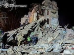 Firefighters work on a site of an apartment building destroyed by a Russian attack in Kryvyi Rih, Ukraine.  