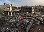 Palestinians stand on the rubble of a building destroyed during Israeli strikes on Rafah, on the southern Gaza Strip, on Nov. 20, 2023, amid continuing battles between Israel and the militant group Hamas.