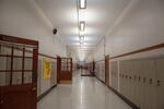 A student walks down an empty hallway at North Salem High School in Salem, Ore., Tuesday, Sept. 17, 2019.