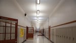 A student walks down an empty hallway at North Salem High School in Salem, Ore., Tuesday, Sept. 17, 2019.