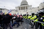Violent insurrections loyal to President Donald Trump break through a police barrier at the Capitol in Washington on Jan. 6, 2021.
