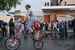 Protesters participating in a naked bike ride pass the U.S. Immigrations and Customs building  in Portland, Ore. on Sunday, Oct. 12, 2025.