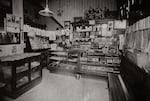 An interior view of a tobacco and newspaper store photographed by Daniel Freeman around 1917, from Reflections in Black.