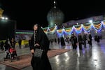 A woman walks through the Shiite Saints Abdulazim and Taher shrine in Shahr-e-Ray, south of Tehran, Iran, Thursday, Jan. 29, 2026.