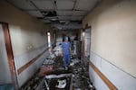 Palestinian hospital staff inspect the destruction inside Nasser hospital in Khan Yunis in the southern Gaza Strip, following an Israeli strike early on May 13, 2025 in which Palestinian journalist Hassan Aslih was killed along with several others.