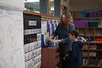 Cherry Park Elementary School third grade teacher Anne O'Brien helps Raiden sharpen his pencil in April 2016.