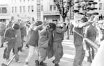 Captured protesters with hands up are led away by government forces on May 27, 1980, in Gwangju, South Korea.