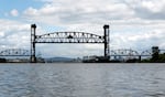 The Burlington Northern Railroad Bridge raises for a ship passing through on the Willamette River in Portland, Ore., on May 29, 2024.