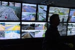 With livestream views of traffic displayed in the background, Rob Brusseau works at the Washington State Department of Transportation (WSDOT) Traffic Management Center on Monday.