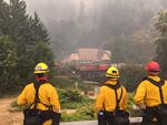 Firefighters survey efforts to save the Historic Multnomah Falls Lodge Tuesday, Sept. 5, 2017. Crews successfully saved the lodge from the Eagle Creek Fire after an all-day effort Tuesday.