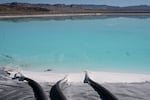 Tubes enter a lithium brine evaporation pool at Silver Peak lithium mine in Silver Peak, Nev. on Oct. 6, 2022.