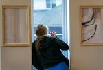 Unable to have visitors, Aleah, 23, can only wave to her boyfriend while detoxing at Recovery Works NW, near Portland, Ore., Dec. 15, 2023. Aleah had been at the facility for five days. Recovery Works is a medication-assisted treatment program, focusing on opiod dependency, that opened a new detox facility last fall, funded by Measure 110. OPB is only identifying Aleah by her first name, because of the stigma attached to addiction.