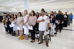 New U.S. citizens stand during a naturalization ceremony in Chicago on June 25, 2025. Newly-naturalized citizens may fall through the cracks of the new citizenship verification tool built by the Department of Homeland Security.