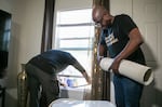 (Left to right) Rele Martinez and Eduardo Diaz with Cooling Portland install a new portable air conditioning unit in the home of a low-income resident of Portland, Ore, July 1, 2025. The Cooling Portland program is one aimed at providing portable cooling equipment to low-income Portland residents, prioritizing those who need it most. 