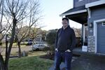 Graphic designer Josh Hull stands outside his West Linn home on Feb. 10, 2023. He lives next door to Tanner Creek pickleball courts. He says the sound genuinely bothers some people.