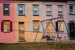 Homes with boarded-up doors and windows sit adjacent to a playground in Baltimore. The Department of Housing and Urban Development handles only about 5% of housing discrimination cases nationwide, and the Trump administration aims to slash three-quarters of the staff in its fair-housing office, according to an internal document seen by NPR.