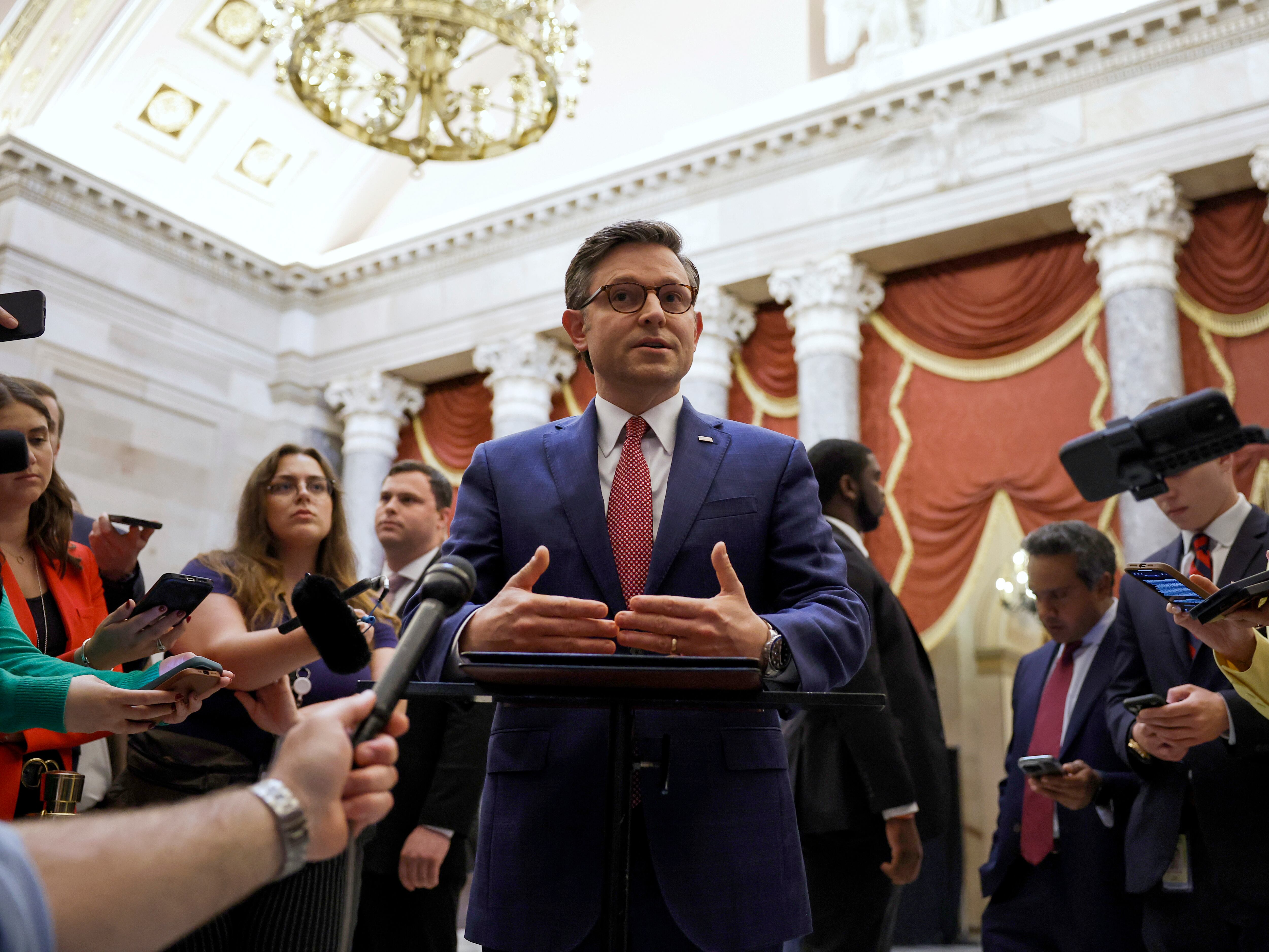 Speaker of the House Mike Johnson speaks with reporters in Statuary Hall after meeting with Reps. Marjorie Taylor Greene and Thomas Massie on May 6.