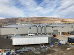 FILE - The exterior of a large brown building housing a Google data center in The Dalles, Ore., is seen in background on the right, in October, 2021.