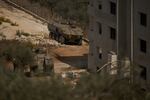 Israeli armored vehicles are seen parked outside a Palestinian building in the West Bank town of Turmus Ayya, Friday, Oct. 23, 2026. (AP Photo/Leo Correa)