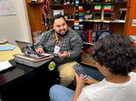 Alberto Plata-Hurtado helps a Benson Polytechnic High School Escalera senior with his FAFSA on April 17, 2024. The Education Department rejected the student’s application due to a spelling error.