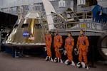 The cardboard cutouts of the Artemis II crew next to the Orion spacecraft mockup give a sense of the scale.