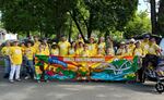 Supporters of Project Sunrise wear bright yellow shirts in this year's Boatnik Parade in Grants Pass. The project, spearheaded by The Oregon Remembrance Project, seeks to create communities as "sunrise towns," where all are welcome and feel safe instead of "sundown towns" that excluded Blacks and other people of color.
