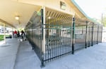A sturdy metal fence at Stillman Park in Pendleton, Ore. keeps people gathering nearby out of a picnic shelter.