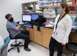 A file photo of Dr. Daniel Streblow, left, and Dr. Donna Hansel in OHSU's in-house COVID-19 testing lab, where staff conduct antibody testing.